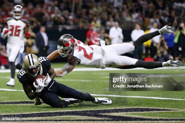 Ted Ginn of the New Orleans Saints catches the ball for a touchdown as Chris Conte of the Tampa Bay Buccaneers defends during the second half of a...