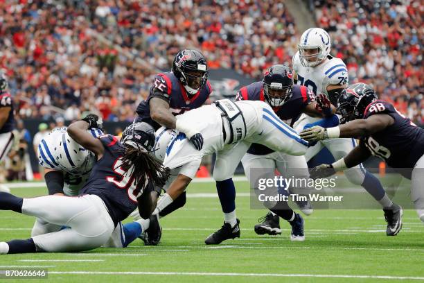 Jacoby Brissett of the Indianapolis Colts is sacked by Jadeveon Clowney of the Houston Texans and Benardrick McKinney in the third quarter at NRG...