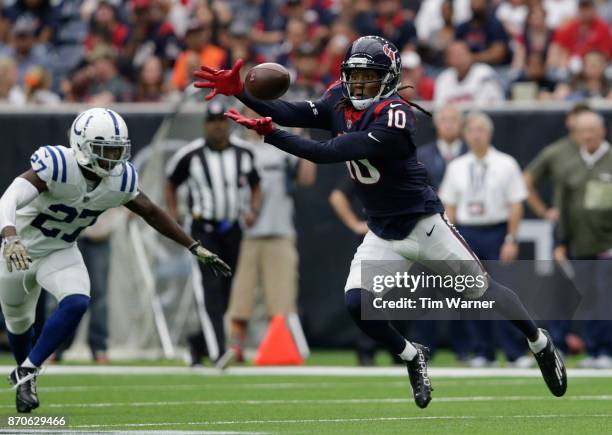 DeAndre Hopkins of the Houston Texans leaps for a pass defended by Nate Hairston of the Indianapolis Colts in the third quarter at NRG Stadium on...