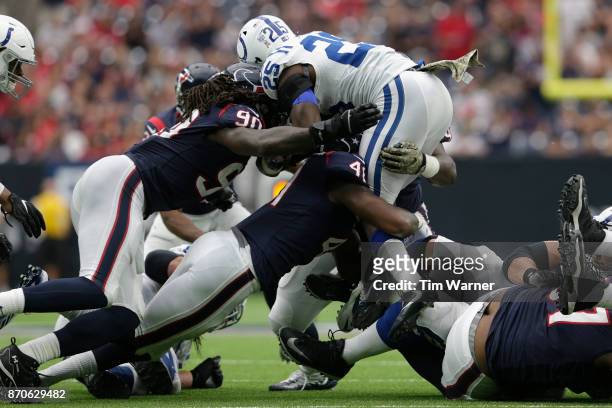 Marlon Mack of the Indianapolis Colts is stopped by Zach Cunningham of the Houston Texans and Jadeveon Clowney of the Houston Texans in the third...