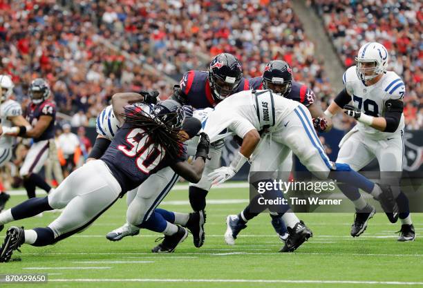 Jacoby Brissett of the Indianapolis Colts is sacked by Jadeveon Clowney of the Houston Texans and Benardrick McKinney in the third quarter at NRG...