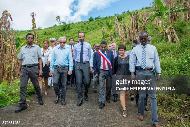 France's Prime Minister Edouard Philippe speaks with Trois Rivieres mayor, Jean-Louis Francisque and President of the Guadeloupe Banana Association,...