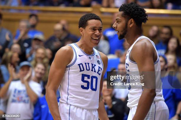 Justin Robinson and Marques Bolden of the Duke Blue Devils react following a dunk by Bolden during their game against the Bowie State Bulldogs at...