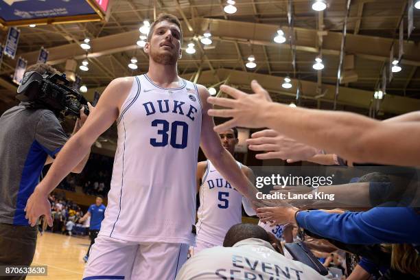 Antonio Vrankovic of the Duke Blue Devils high-fives fans following their game against the Bowie State Bulldogs at Cameron Indoor Stadium on November...