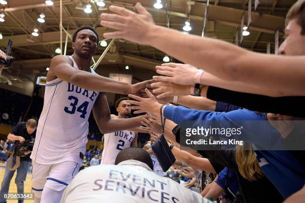Wendell Carter, Jr. #34 of the Duke Blue Devils high-fives fans following their game against the Bowie State Bulldogs at Cameron Indoor Stadium on...