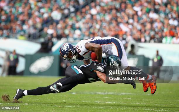 Cornerback Patrick Robinson of the Philadelphia Eagles tackles wide receiver Demaryius Thomas of the Denver Broncos during the second quarter at...