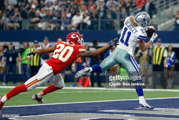 Steven Nelson of the Kansas City Chiefs defends as Cole Beasley of the Dallas Cowboys pulls in a pass for a touchdown in the first quarter of a...