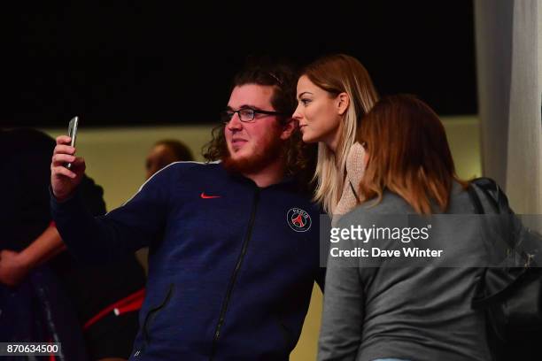 Women's footballer Laure Boulleau poses for a selfie with a fan during the Champions League match between Paris Saint Germain and Kielce on November...