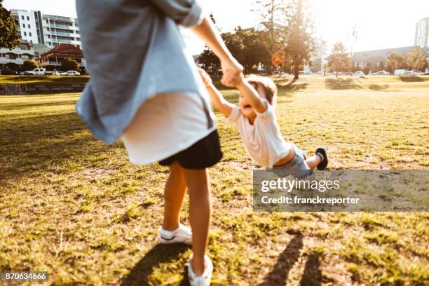 brothers playing together at the park - brisbane transport stock pictures, royalty-free photos & images