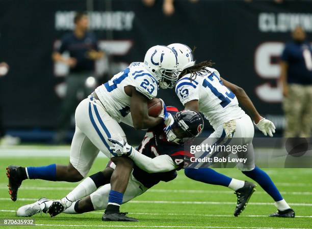 Frank Gore of the Indianapolis Colts is tackled by Corey Moore of the Houston Texans as T.Y. Hilton misses a block at NRG Stadium on November 5, 2017...