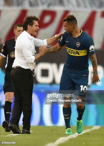 Edwin Cardona of Boca Juniors celebrates with his coach Guillermo Barros Schelotto after scoring the first goal of his team during a match between...