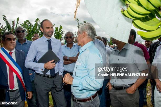 France's Prime Minister Edouard Philippe speaks with Mayor of Trois Rivieres Jean-Louis Francisque and President of the Guadeloupe Banana...