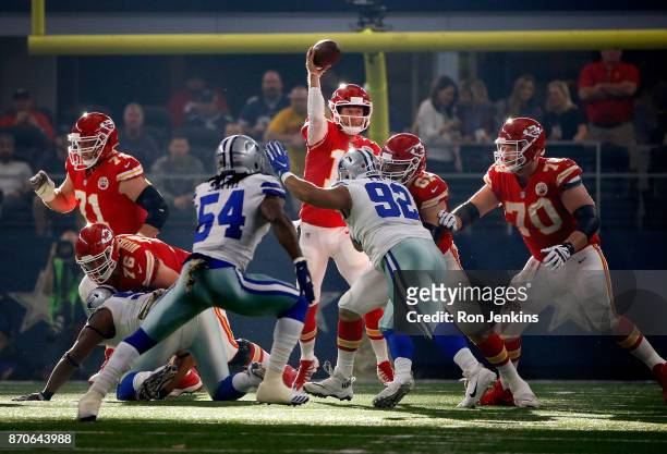 Alex Smith of the Kansas City Chiefs passes the ball under pressure from Jaylon Smith of the Dallas Cowboys and Brian Price of the Dallas Cowboys in...
