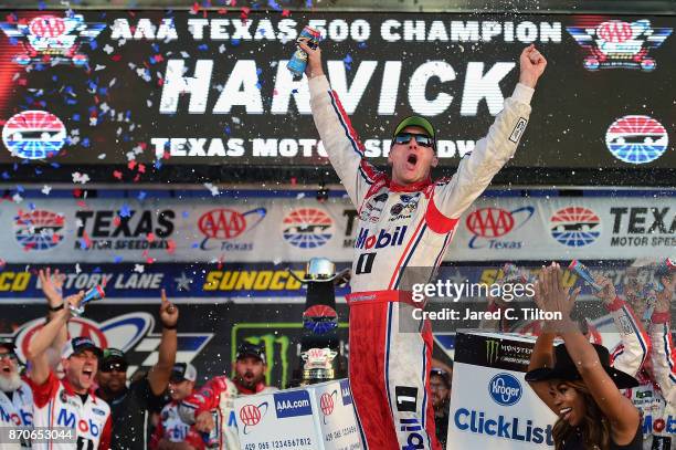 Kevin Harvick, driver of the Mobil 1 Ford, celebrates in Victory Lane after winning the Monster Energy NASCAR Cup Series AAA Texas 500 at Texas Motor...