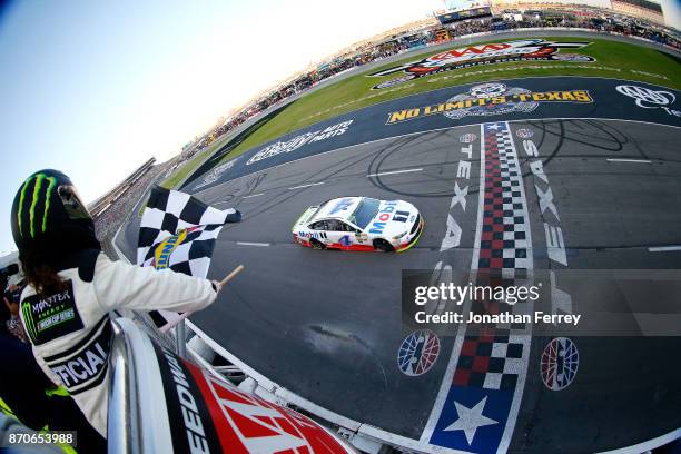 Kevin Harvick, driver of the Mobil 1 Ford, takes the checkered flag to win the Monster Energy NASCAR Cup Series AAA Texas 500 at Texas Motor Speedway...