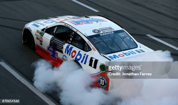 Kevin Harvick, driver of the Mobil 1 Ford, celebrates with a burnout after winning the Monster Energy NASCAR Cup Series AAA Texas 500 at Texas Motor...