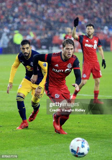 Nicolas Hasler of Toronto FC Gonzalo Veron of New York Red Bulls chase the ball during the second half of the MLS Eastern Conference Semifinal, Leg 2...