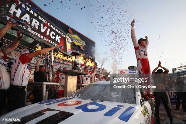 Kevin Harvick, driver of the Mobil 1 Ford, celebrates in Victory Lane after winning the Monster Energy NASCAR Cup Series AAA Texas 500 at Texas Motor...