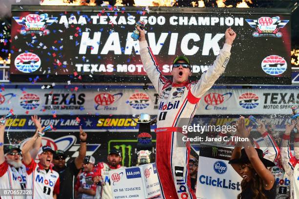 Kevin Harvick, driver of the Mobil 1 Ford, celebrates in Victory Lane after winning the Monster Energy NASCAR Cup Series AAA Texas 500 at Texas Motor...