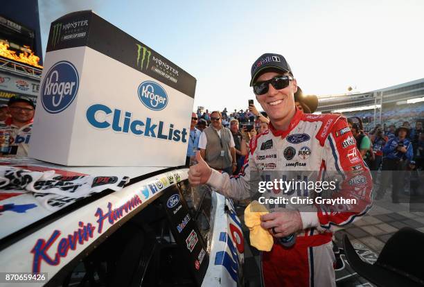 Kevin Harvick, driver of the Mobil 1 Ford, poses with the winners decal in Victory Lane after winning the Monster Energy NASCAR Cup Series AAA Texas...