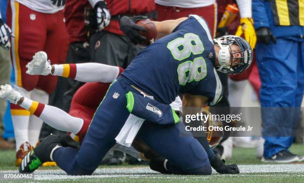 Tight end Jimmy Graham of the Seattle Seahawks is tackled by cornerback Josh Norman of the Washington Redskins at CenturyLink Field on November 5,...