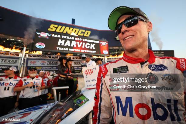 Kevin Harvick, driver of the Mobil 1 Ford, celebrates in Victory Lane after winning the Monster Energy NASCAR Cup Series AAA Texas 500 at Texas Motor...