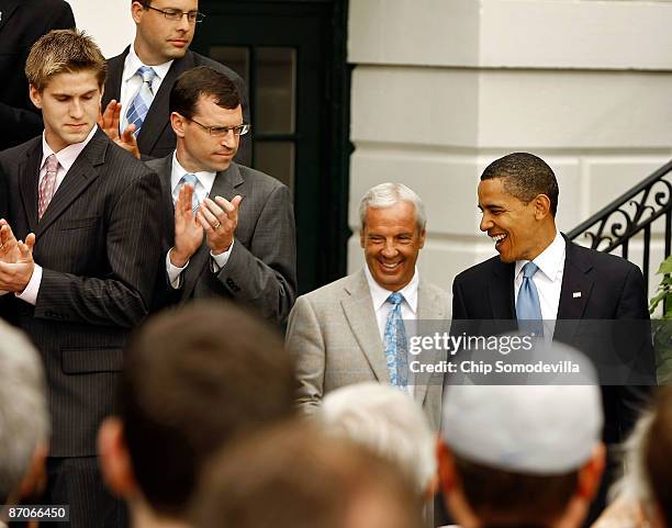 President Barack Obama and University of North Carolina men's basketball head coach Roy Williams walk out before Obama delivers remarks at the White...