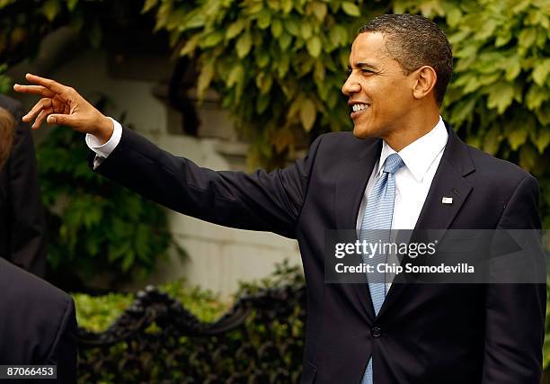 President Barack Obama waves goodbye to guests after welcoming members of the University of North Carolina men's basketball team to the White House...