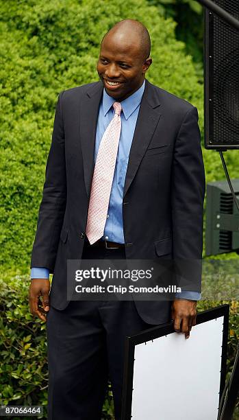 President Barack Obama's personal assistant Reggie Love stands by and watches Obama welcome members of the University of North Carolina men's...