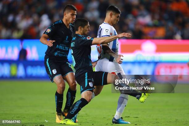 Victor Guzman of Pachuca struggles for the ball with Javier Guemez of Queretaro during the 16th round match between Pachuca and Queretaro as part of...