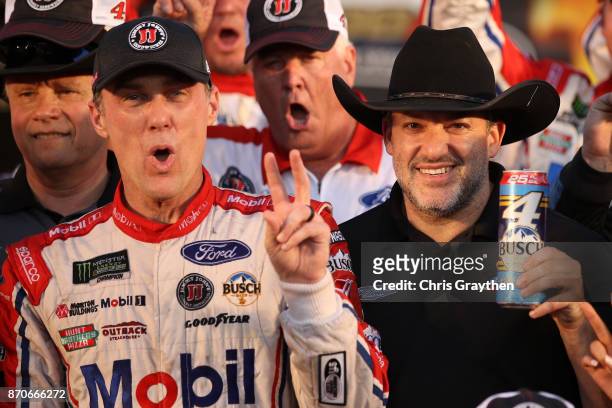 Kevin Harvick, driver of the Mobil 1 Ford, and team owner Tony Stewart celebrate in Victory Lane after winning the Monster Energy NASCAR Cup Series...