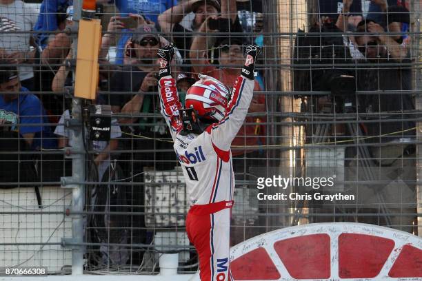 Kevin Harvick, driver of the Mobil 1 Ford, celebrates after winning the Monster Energy NASCAR Cup Series AAA Texas 500 at Texas Motor Speedway on...
