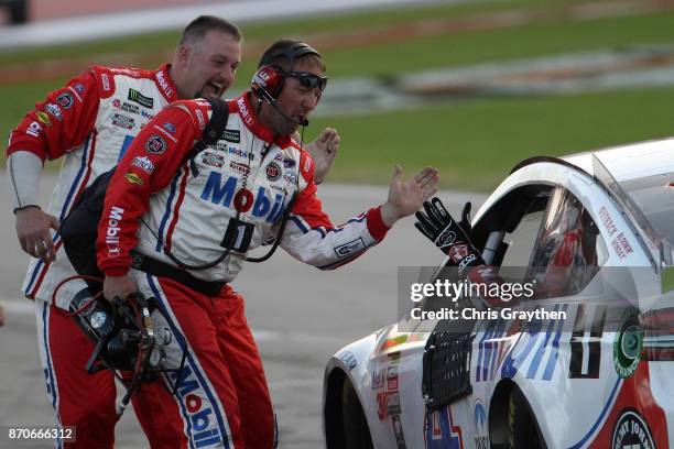 Kevin Harvick, driver of the Mobil 1 Ford, celebrates after winning the Monster Energy NASCAR Cup Series AAA Texas 500 at Texas Motor Speedway on...