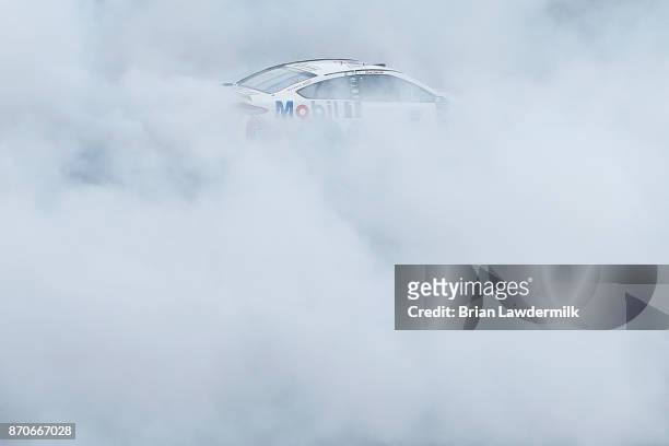Kevin Harvick, driver of the Mobil 1 Ford, celebrates with a burnout after winning the Monster Energy NASCAR Cup Series AAA Texas 500 at Texas Motor...