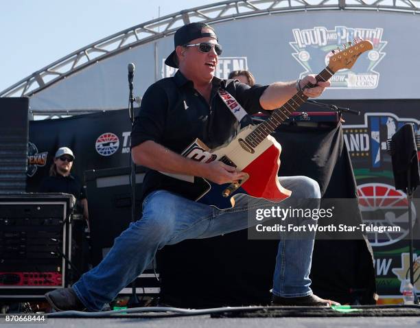 Pat Green plays a guitar handed up from a fan in the crowd before the Texas AAA 500 at Texas Motor Speedway on Sunday. Nov. 5, 2017.