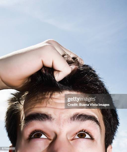 man pulling his hair - pulling hair stock pictures, royalty-free photos & images