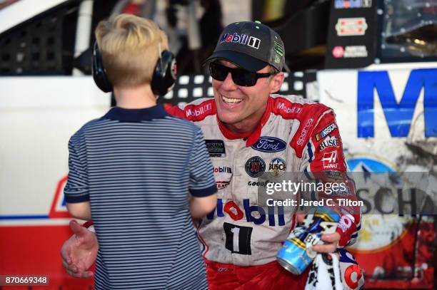 Kevin Harvick, driver of the Mobil 1 Ford, celebrates with his son, Keelan, in Victory Lane after winning the Monster Energy NASCAR Cup Series AAA...