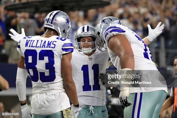 Terrance Williams of the Dallas Cowboys and La'el Collins of the Dallas Cowboys ceelbrate the fourth quarter touchdown by Cole Beasley of the Dallas...