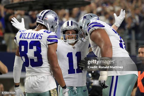 Terrance Williams of the Dallas Cowboys and La'el Collins of the Dallas Cowboys ceelbrate the fourth quarter touchdown by Cole Beasley of the Dallas...