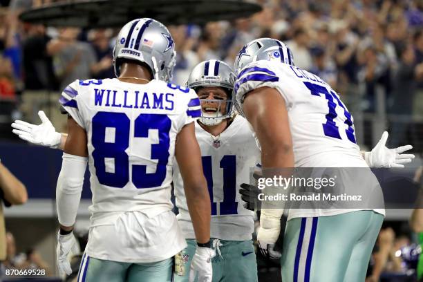 Terrance Williams of the Dallas Cowboys and La'el Collins of the Dallas Cowboys celebrate the touchdown by Cole Beasley of the Dallas Cowboys in the...