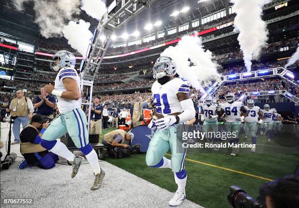 Dak Prescott and Ezekiel Elliott of the Dallas Cowboys runs onto the field before a game against the Kansas City Chiefs at AT&T Stadium on November...