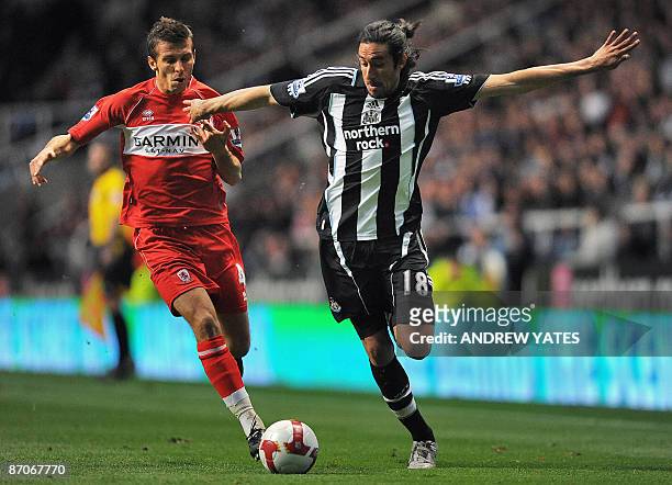 Newcastle United's Argentinian midfielder Jonás Gutiérrez is challenged by Middlesbrough's English midfielder Gary O'Neil during their English...