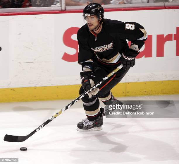 Teemu Selanne of the Anaheim Ducks handles the puck alongside the boards against the Detroit Red Wings during Game Four of the Western Conference...