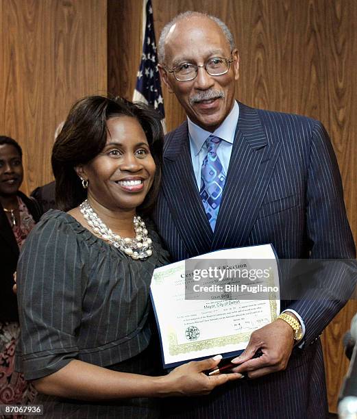 Former Detroit Pistons' star Dave Bing poses with City Clerk Janice Winfrey and his certificate of election after being sworn in as the 62nd mayor of...