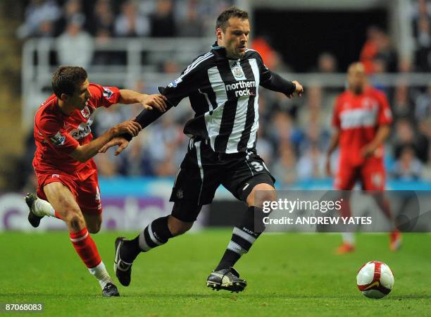 Newcastle United's Australian forward Mark Viduka is challenged by Middlesbrough's English midfielder Gary O'Neil during their English Premier League...