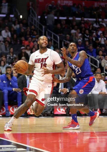 Miami Heat forward James Johnson dribbles past Los Angeles Clippers guard Lou Williams on November 05 at the Staples Center in Los Angeles, CA.