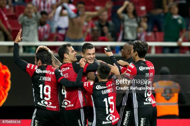 Milton Caraglio of Atlas celebrates with teammates after scoring the second goal of his team during the 16th round match between Chivas and Atlas as...