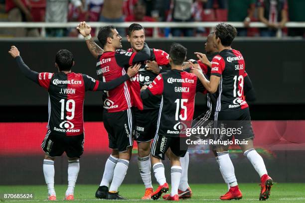 Milton Caraglio of Atlas celebrates with teammates after scoring the second goal of his team during the 16th round match between Chivas and Atlas as...