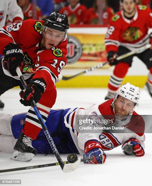 Jonathan Toews of the Chicago Blackhawks tries to get off a shot against Karl Alzner of the Montreal Canadiens at the United Center on November 5,...