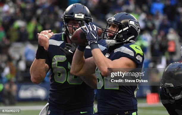 Tight end Luke Willson of the Seattle Seahawks celebrates with center Justin Britt after scoring a touchdown during the fourth quarter of the game...